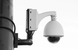 Outdoor PTZ CCTV security camera mounted on a metal pole for remote surveillance and 360-degree security monitoring.
