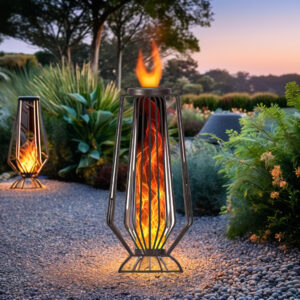 Decorative solar flame garden light with a realistic flickering orange flame effect illuminating a landscaped garden pathway at dusk.